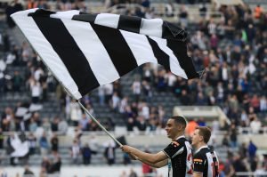 miguel-almiron-waves-a-newcastle-united-flag-after-beating-leicester-city-in-the-premier-league-2022